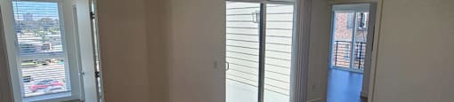 Empty room with wooden floors and white walls.