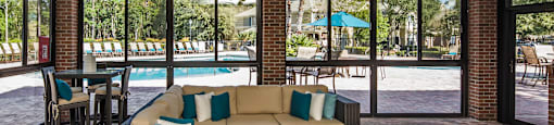 a living room with couches and chairs and a pool