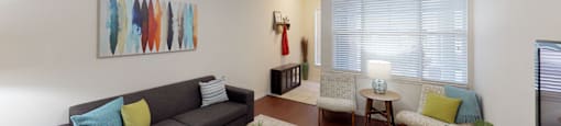 a living room with a couch and a ceiling fan