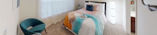 a bedroom with a bed and a ceiling fan