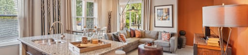 a living room with a kitchen and a couch