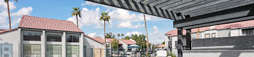 A pool with a metal railing and a building in the background.