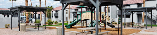 A playground with a slide and a pavilion.
