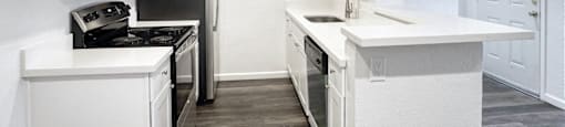 apartment kitchen with white cabinets and stainless steel appliances