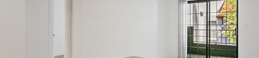 A large, empty room with a black countertop and white walls.