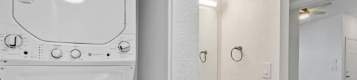 A white bathroom with a toilet, sink, and mirror.
