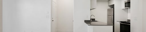 A kitchen with a white counter and black appliances.