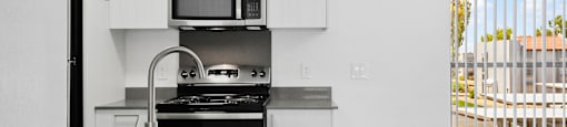 A modern kitchen with a stainless steel sink and countertop.