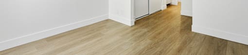 A room with a wooden floor and white walls.