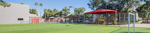 A soccer field with a red canopy and goal post.