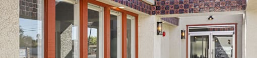 A building with a red tile roof and a glass door.