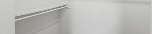 Empty white shelves in a room.