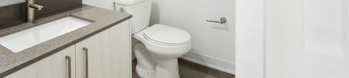 a bathroom with a sink toilet and shower