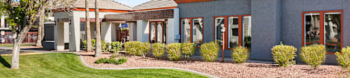 a building with a grassy yard in front of it