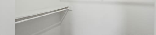 Empty white shelves in a room.