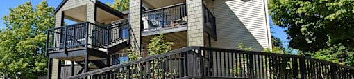 A modern house with a balcony and a black railing.
