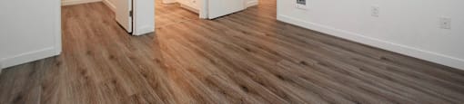 A room with a wooden floor and white walls.