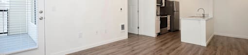 A room with wooden floors and white walls.