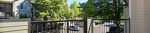 A black gate leads to a driveway.