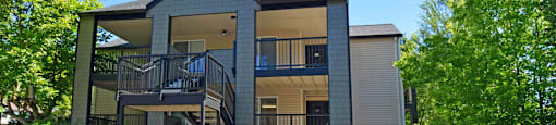 A two-story house with a balcony on the second floor.