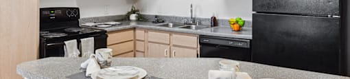 Kitchen with black appliances at Tidwell Estates in Houston TX