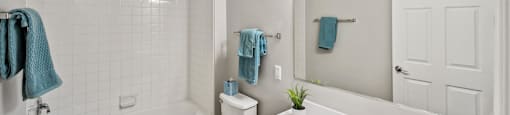 Bathroom with shower and sink at England Run Apartments in Fredericksburg VA