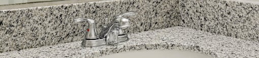 Granite bathroom vanity at Brenton at Abbey Park Apartments in West Palm Beach FL