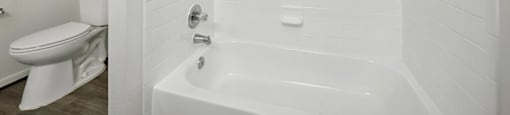 Bathroom with white tile at Fountains at Tidwell and The Enclave in Houston TX