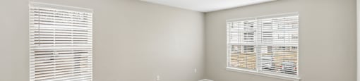 Bedroom with large windows at England Run Apartments in Fredericksburg VA