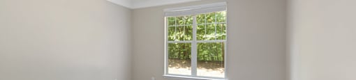 Bedroom with window at Falls Pointe at the Park Apartments in Durham NC