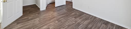 Two Bedroom Apartments in North Dallas TX - Tivoli - Well Lit Bedroom with Wood Plank Flooring, Oversized Closet, Large Windows, and En Suite Bathroom