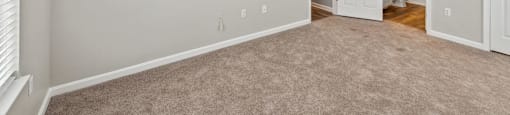 Carpeted bedroom with en suite at England Run Apartments in Fredericksburg VA