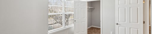 Bedroom with walk in closet and carpet at England Run Apartments in Fredericksburg VA