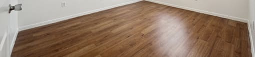 Bedroom with hardwood flooring at Fountains at Tidwell and The Enclave in Houston TX