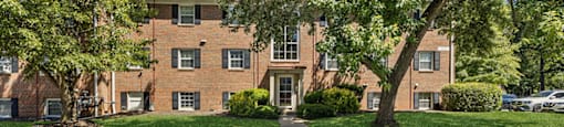 Building exterior with trees surrounding at Villages at Marley Station in Glen Burnie MD