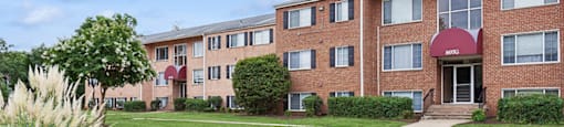 Building exterior with lawn at Leesburg Apartments in Leesburg VA