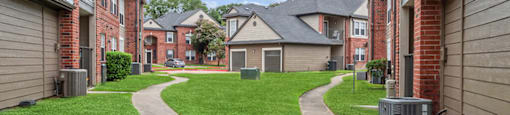Walkway in between buildings at Hollow Creek Apartments in Conroe TX