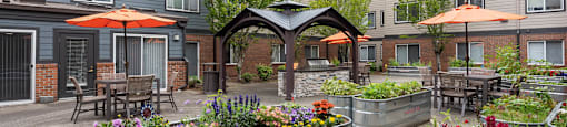 Senior Apartments In Federal Way - Renovated Courtyard With Community Garden Planters. There Is Plenty Of Seating And Tables Available