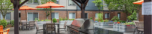 Senior Apartments Federal Way - Brand-New Grilling Area In A Renovated Courtyard With Plenty Of Seating And Tables