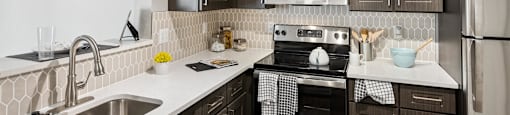 Kitchen with dark cabinets at England Run Apartments in Fredericksburg VA