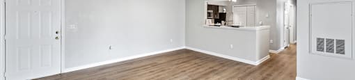 Open concept apartment with hardwood style flooring at England Run Apartments in Fredericksburg VA