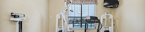 Fitness room with machines at Parkway Senior Apartments in Pasadena TX