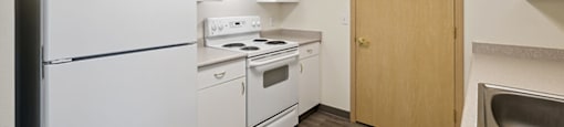a kitchen with white appliances and white cabinets