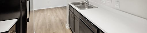 Kitchen with black appliances at Bonito Parque Apartments in San Antonio TX