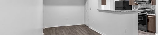 Living room with view of kitchen at Cedar Grove Apartments in Miami Gardens FL