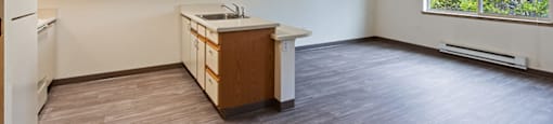 Kitchen and living room at Woodrose Senior Affordable Apartments in Bellingham WA