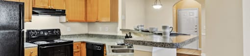 Kitchen with black appliances at Longwood Vista Apartment Homes in Atlanta GA