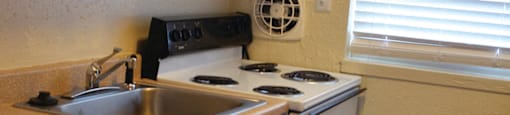 Stove and counter space at Whispering Oaks Apartments in Portsmouth VA
