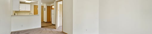 Living room with wood style flooring at Woodlands at Forbes Lake Apartments in Kirkland WA