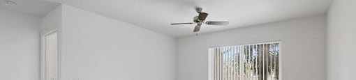 Living room with ceiling fan at Brenton at Abbey Park Apartments in West Palm Beach FL